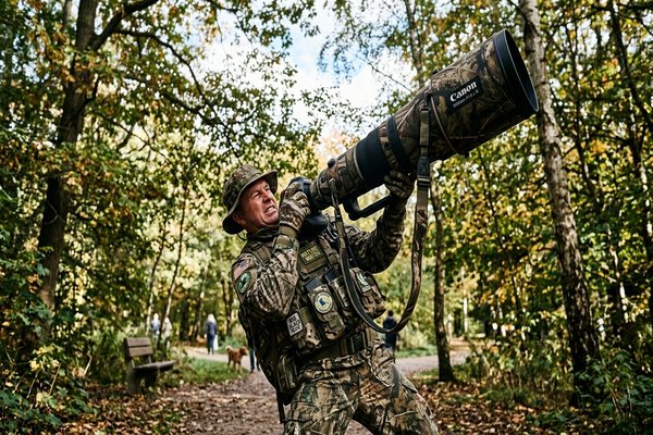 A photographer with an absurdly large camera lens